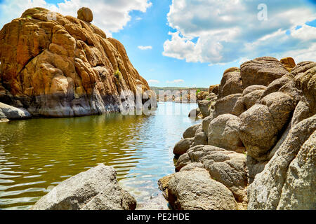 Water in Watson Lake, Prescott, Arizona, surrounded by large granite boulders Stock Photo