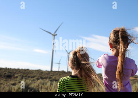 Two young children watching the windmills Stock Photo