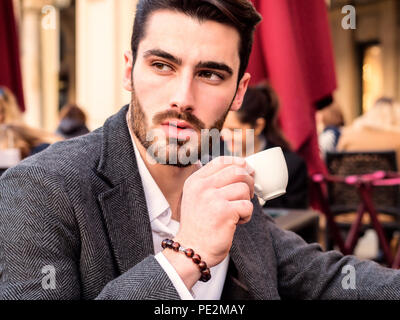 Handsome young businessman drinking espresso coffee Stock Photo