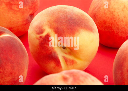white peach closeup on red background Stock Photo