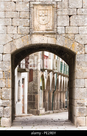 city wall and gate to historical shopping area of Trancoso, Centro, Beira Interior Norte, Portugal Stock Photo