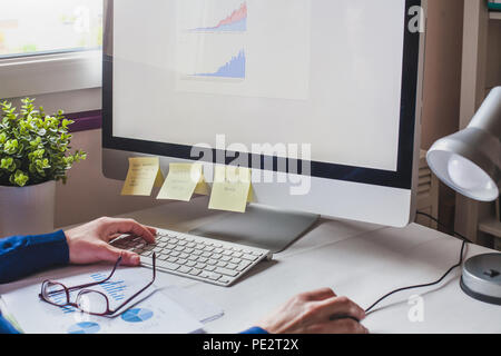 business man analyzing financial report on screen of computer, finance analytics of company performance Stock Photo