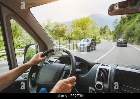hands of truck driver on steering wheel, delivery service, transportation occupation, man driving big cargo car on the road Stock Photo