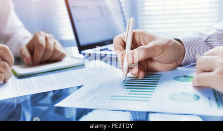 business analytics, team of people working on financial report in the office, teamwork, closeup of hands Stock Photo