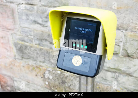 Digital bank credit card reader located outdoors at train station car park Stock Photo