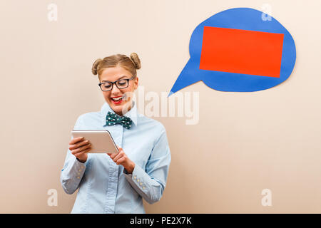 Nerdy woman using digital tablet Stock Photo