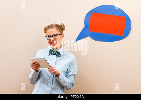 Nerdy woman using digital tablet Stock Photo