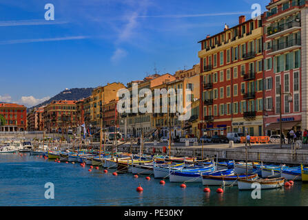 Nice, France - May 24, 2018: Old classic wooden boats and traditional Mediterranean buildings in Lympia port of Nice, Côte d'Azur Stock Photo