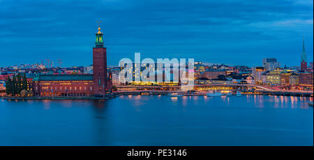 Central Stockholm, Sweden - October 24, 2017:  Sunset panorama across Lake Malaren onto City Hall Stadshuset in Kungsholmen and Klara or Claire Church Stock Photo