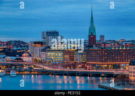 Central Stockholm, Sweden - October 24, 2017: Sunset view across Lake Malaren onto traditional gothic buildings in Normalm and Klara Church or Claire  Stock Photo