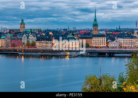 Stockholm, Sweden - October 24, 2017: Sunset view across Lake Malaren onto traditional gothic buildings in the old town, Gamla Stan and German church. Stock Photo