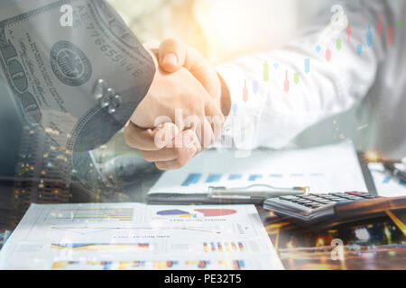 Double exposure of handshake and night city, Successful negotiating business concept, Businessmen shaking hands after finishing meeting or setting  go Stock Photo