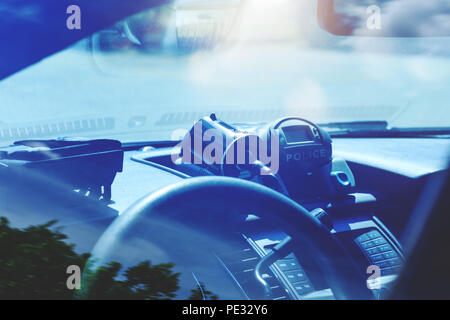 Police radar inside of police car. Patrol monitors traffic on a highway or on the roads of municipal district. Modern speed trap at a road. Policemen  Stock Photo