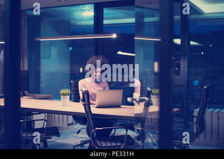 Young african american female Entrepreneur Freelancer Working Using A Laptop In Coworking space Stock Photo