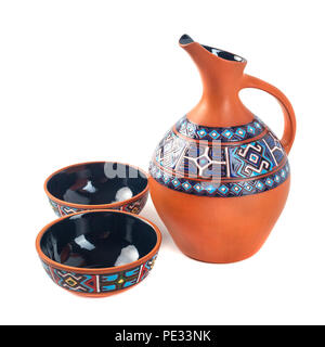 Georgian handmade ceramic (clay) jug with tradicional ornaments on it, named Doqi, and cup, named tasi, for wine and water on white background. Stock Photo