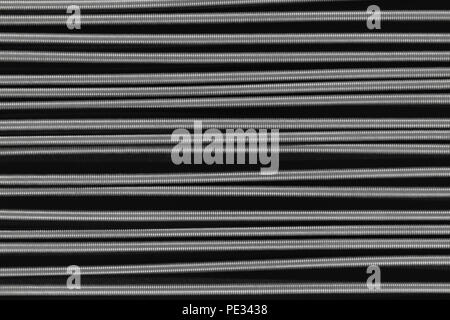 Metal springs placed horizontally on black background surface Stock Photo