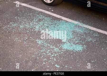 Shattered car window glass on the ground at a car park Stock Photo