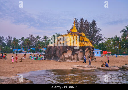 CHAUNG THA, MYANMAR - FEBRUARY 28, 2018: The sunset coast of Bengal Bay with a view on Kyauk Pa Hto Pagoda, covered with gilt and surrounded by street Stock Photo