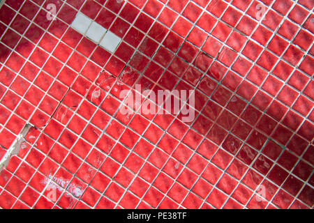 Small red tiles with some distressed areas completely filling the frame for use as a background Stock Photo