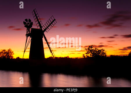 Turf Fen Windmill on the Norfolk Broads against a red evening sky. Stock Photo