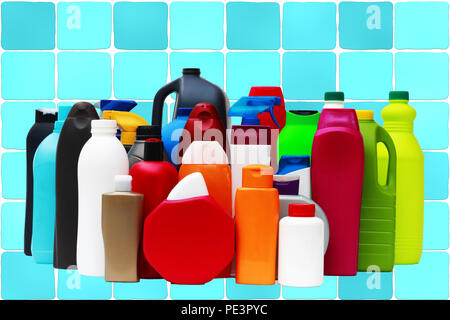Plastic containers of different shapes and colors on a seamless background of tiles in blue tones Stock Photo