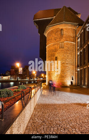 The Crane on Dlugie Pobrzeze street at night in Gdansk, Poland, city symbol and landmark from 15th century, Motlawa River waterfront Stock Photo