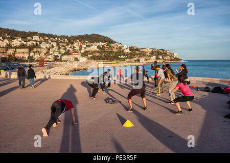 People in outdoor aerobic class training on sea promenade in city of Nice on French Riviera in France Stock Photo