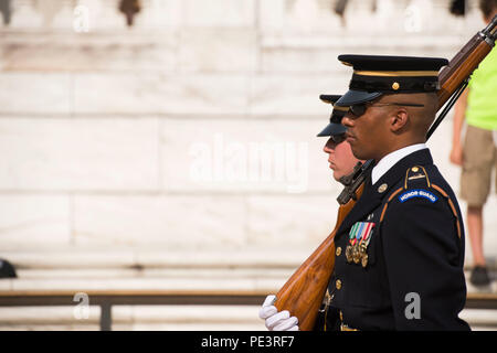 Tomb Sentinels, part of the 3rd U.S. Infantry Regiment (The Old Guard), take part in a Changing of the Guard ceremony at the Tomb of the Unknown Soldier in Arlington National Cemetery, Sept. 2, 2015, in Arlington, Va. Dignitaries from all over the world pay respects to those buried at Arlington National Cemetery in more than 3,000 ceremonies each year. (U.S. Army photo by Rachel Larue/Released) Stock Photo