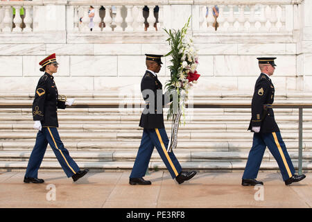 A member of the U.S. Army Band “Pershing’s Own,” left, and Tomb Sentinels, part of the 3rd U.S. Infantry Regiment (The Old Guard), take part in a Changing of the Guard ceremony at the Tomb of the Unknown Soldier in Arlington National Cemetery, Sept. 2, 2015, in Arlington, Va. Dignitaries from all over the world pay respects to those buried at Arlington National Cemetery in more than 3,000 ceremonies each year. (U.S. Army photo by Rachel Larue/Released) Stock Photo