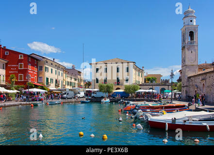 Boats at the harbour, San Nicolo church, Lazise, Garda lake, province Verona, Italy Stock Photo