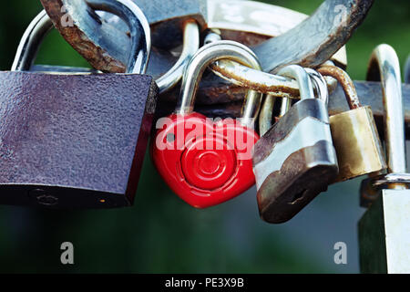 Padlock as form heart on fence on bridge in Kiev, symbol of love Stock Photo