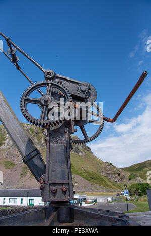 The lifting gear used to load and unload the boats in the square at Ellenabeich by the Isle of Seil in Argyle Scotland not far from Oban in the Highla Stock Photo