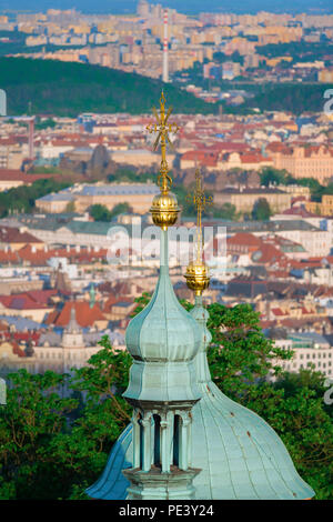 Prague view city, aerial view of onion domes on top of St Lawrence Church on Petrin Hill, against the backdrop of the Nove Mesto district, Prague. Stock Photo