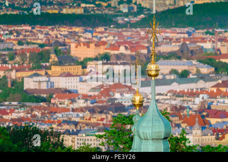 Prague city view, aerial view of an onion dome on top of St Lawrence Church on Petrin Hill, against the backdrop of the Nove Mesto district, Prague. Stock Photo