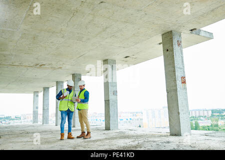 Construction engineers discussing project Stock Photo