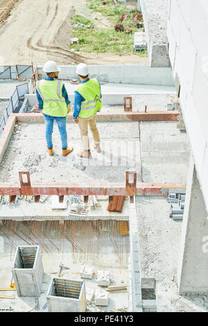 Construction engineers on cement slab Stock Photo