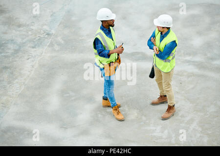 Engineers speaking on construction site Stock Photo