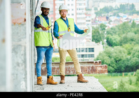 Engineers with draft inspecting construction site Stock Photo