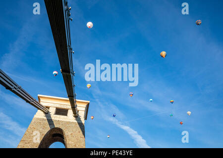 Hot air balloons in flight above the Clifton suspension bridge during the mass ascent of the Bristol Balloon Fiesta Stock Photo