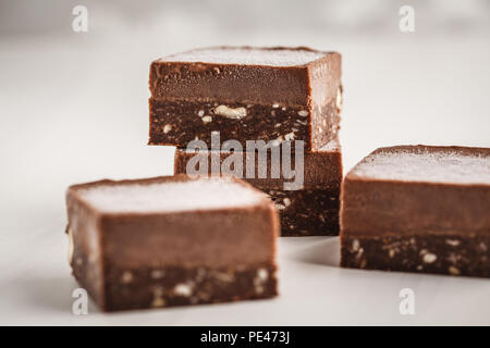 Chocolate fudge bars on white background. Clean eating concept. Raw vegan dessrt. Stock Photo