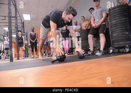 Mr. Tony Horton instructor and founder of P 90X shows how to conduct kettlebell push ups at Ardent Crossfit Stafford Va. Sept 3 2015. Horton taught several active duty members different ways to learn ...