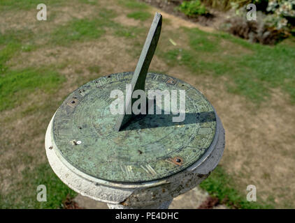 Antique sun dial in an English garden on summers day Stock Photo