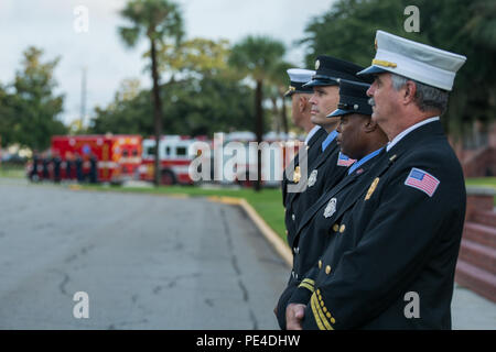 Members of the Parris Island Fire Department observe morning colors Sept. 11, 2015, on Parris Island, S.C. This ceremony brought together Marines and other emergency responders to remember those lost Sept. 11, 2001, when terrorist attacks claimed almost 3,000 lives. Stock Photo