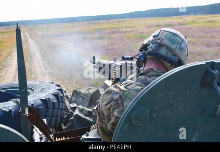 U.S. Army Pfc. David Quick, an indirect-fire infantryman assigned to P Troop, 4th Squadron, 2nd Cavalry Regiment, fires his weapon at a target from a Stryker reconnaissance vehicle during a mounted training exercise Sept. 10, 2015 at the Drawsko Pomorskie Training Area. The training is part of Operation Atlantic Resolve, an ongoing multinational partnership focused on combined training and security cooperation between NATO allies. (U.S. Army photo by Sgt. Brandon Anderson, 13th Public Affairs Detachment.) Stock Photo