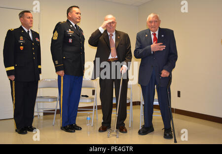 (From left) Brig. Gen. Steven Ainsworth, commander of the 94th Training Division, Command Sgt. Maj. Arlindo Almeida, senior noncommissioned officer 94th TD, and WWII veterans Andrew Cella and Vincenzo Geramita. Ainsworth awarded Cella and Geramita their well-deserved Bronze Star medals, after 70 years, during an intimate ceremony filled with family, friends and service members at Fort Dix, N.J., Sept. 12, 2015. Stock Photo