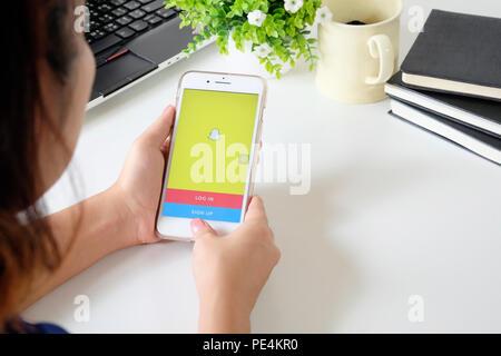 CHIANG MAI,THAILAND - JULY 24, 2018 : Apple iPhone 7 Plus in one hand showing its screen with Snapchat application. Stock Photo