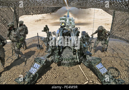 U.S. Soldiers assigned to Battery A, 2nd Battalion, 12th Field Artillery Regiment, 1st Brigade Combat Team, 4th Infantry Division, fire an M777 Light Towed Howitzer during calibration for Decisive Action Rotation 15-10 at the National Training Center, Fort Irwin, Calif., Sept. 10, 2015.  Decisive Action rotations create a realistic training environment that tests the capabilities of brigade combat teams preparing them to face similarly equipped opposing forces. (U.S. Army photo by Spc. Ashley Marble/Released) Stock Photo