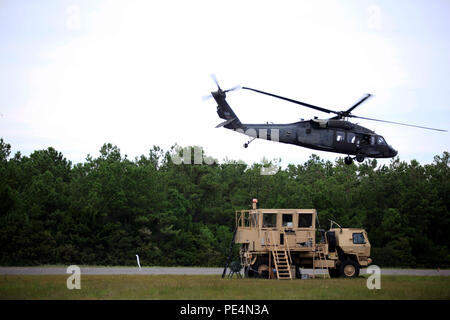 Air Traffic Controllers from 3rd General Support Aviation Battalion manage airspace as UH-60 Black Hawk helicopters take off from Cherry Point, N.C., using a mobile tower system. Controllers ensure safe separation, deconflict flight paths, and maintain operational oversight. Training emphasizes air traffic management, helicopter coordination, safety procedures, and real-time communication. Exercises support operational readiness, pilot proficiency, and effective control of aviation operations for combat aviation brigades. Stock Photo