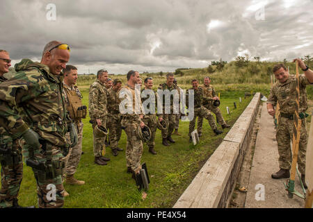 Senior Officer and Enlisted representatives from international teams receive a brief on targets used in the Royal Marine Operational Shooting Competition (RMOSC), hosted by the British Royal Marines at Altrar Training Camp, Hightown, England, Sept. 9-16, 2015. The purpose of the RMOSC is to evaluate the marksmanship skill, and physical and operational abilities of American, British, French, and Dutch Marines in combat related shooting matches by utilizing realistic structures, fast-moving targets, and movement to contact drills. (U.S. Marine Corps photo by Cpl. Timothy Turner/Released) Stock Photo