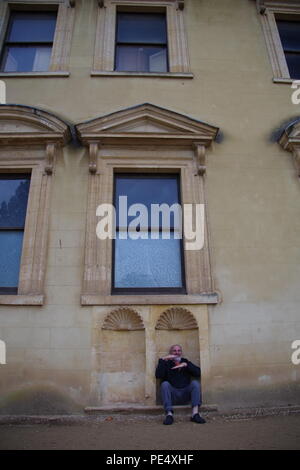 58 Year Old Man Sitting in an Architectural Recess at Ashton Court Mansion, Estate. Bristol, UK. Stock Photo